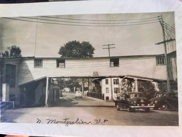 Mid-1900s postcard captioned "N. Montpelier, Vt." showing parked cars and village storefronts.